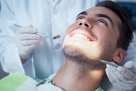 simsearch:6109-08389794,k - Close up of man having his teeth examined by dentist Stockbilder - Microstock & Abonnement, Bildnummer: 400-07939200