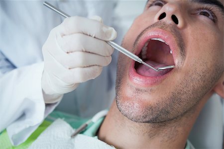 simsearch:6109-08389794,k - Close up of man having his teeth examined by dentist Stockbilder - Microstock & Abonnement, Bildnummer: 400-07939201