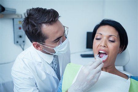 simsearch:400-07938824,k - Male dentist examining womans teeth in the dentists chair Foto de stock - Super Valor sin royalties y Suscripción, Código: 400-07939257