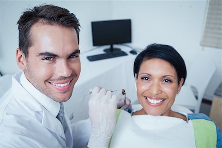 simsearch:6109-08389794,k - Male dentist examining womans teeth in the dentists chair Stockbilder - Microstock & Abonnement, Bildnummer: 400-07939265