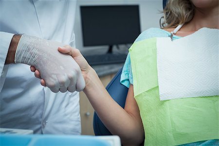 pictures of two nurses shaking hands - Close up mid section of male dentist shaking hands with woman Stock Photo - Budget Royalty-Free & Subscription, Code: 400-07939307