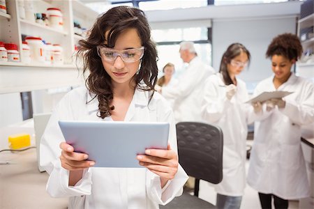 school biology - Science student looking at tablet pc in the lab at the university Stock Photo - Budget Royalty-Free & Subscription, Code: 400-07939522