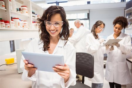 Science student holding tablet pc in lab at the university Stock Photo - Budget Royalty-Free & Subscription, Code: 400-07939523