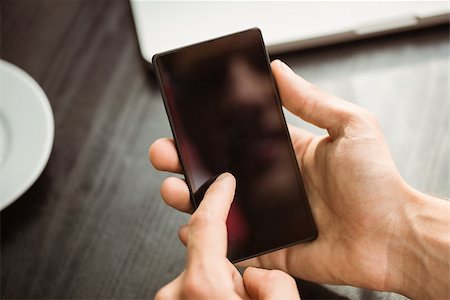 simsearch:400-08056574,k - Student touching his mobile phone in cafe at the university Stock Photo - Budget Royalty-Free & Subscription, Code: 400-07939554