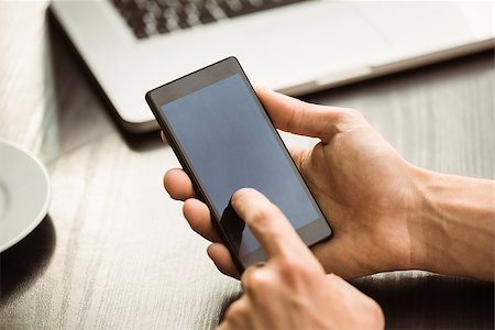 simsearch:400-08056574,k - Student touching his mobile phone in cafe at the university Stock Photo - Budget Royalty-Free & Subscription, Code: 400-07939552