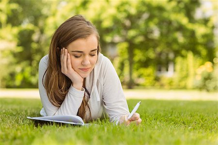 simsearch:400-07939821,k - University student lying and writing on notepad in park at school Photographie de stock - Aubaine LD & Abonnement, Code: 400-07939639