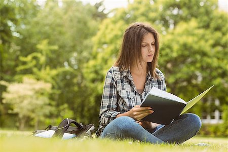 simsearch:400-07939821,k - University student standing reading book in park at school Photographie de stock - Aubaine LD & Abonnement, Code: 400-07939630