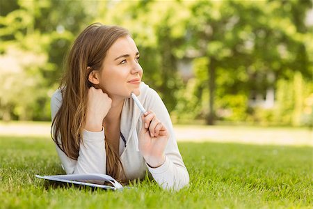 simsearch:400-07939821,k - Smiling university student lying and thinking in park at school Photographie de stock - Aubaine LD & Abonnement, Code: 400-07939641