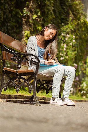simsearch:400-07939821,k - Smiling student sitting on bench and writing on notepad in park at school Photographie de stock - Aubaine LD & Abonnement, Code: 400-07939659