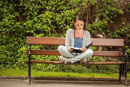 students campus phones - Student sitting on bench listening music with mobile phone and revising in park at school Stock Photo - Budget Royalty-Free & Subscription, Code: 400-07939667