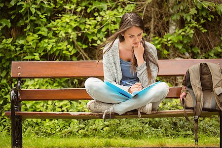 reading on park bench - Smiling student sitting on bench reading book in park at school Stock Photo - Budget Royalty-Free & Subscription, Code: 400-07939662