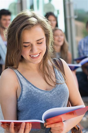 simsearch:400-07939821,k - Pretty student reading from notepad at the university Photographie de stock - Aubaine LD & Abonnement, Code: 400-07939778