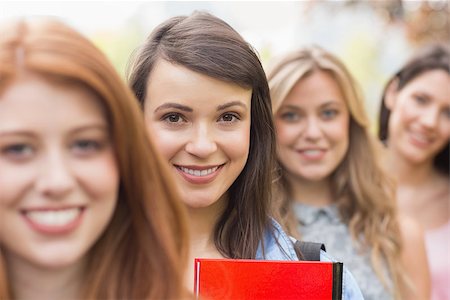 simsearch:400-07939821,k - Happy students smiling at camera in a row at the university Photographie de stock - Aubaine LD & Abonnement, Code: 400-07939794