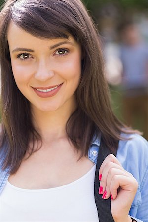 simsearch:400-07939821,k - Pretty student smiling at camera outside on campus at the university Photographie de stock - Aubaine LD & Abonnement, Code: 400-07939804