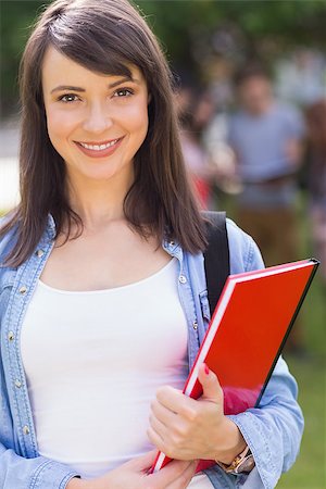 simsearch:400-07939821,k - Pretty student smiling at camera outside on campus at the university Photographie de stock - Aubaine LD & Abonnement, Code: 400-07939802