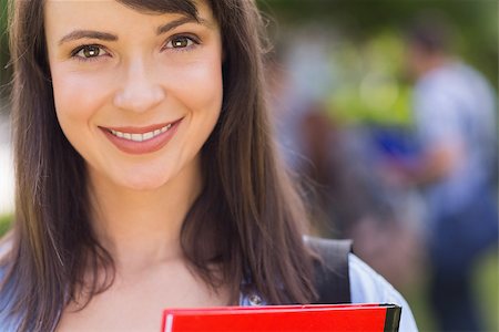 simsearch:400-07939821,k - Pretty student smiling at camera outside on campus at the university Photographie de stock - Aubaine LD & Abonnement, Code: 400-07939803