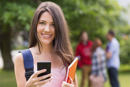 students campus phones - Pretty student sending a text outside on campus at the university Stock Photo - Budget Royalty-Free & Subscription, Code: 400-07939814