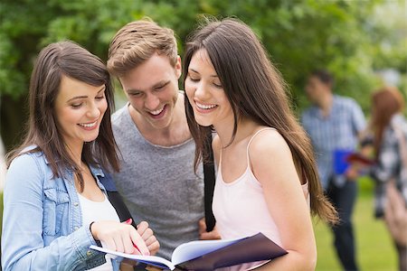 simsearch:400-07939821,k - Happy students reading from notepad at the university Photographie de stock - Aubaine LD & Abonnement, Code: 400-07939822