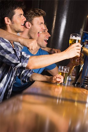 friends smiling 30 beer - Happy friends catching up over pints in a bar Stock Photo - Budget Royalty-Free & Subscription, Code: 400-07939861