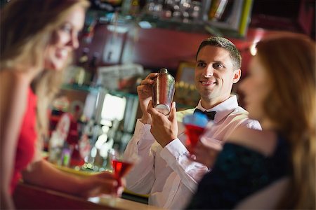 simsearch:693-06021224,k - Handsome barman chatting to customers in a bar Stock Photo - Budget Royalty-Free & Subscription, Code: 400-07939885