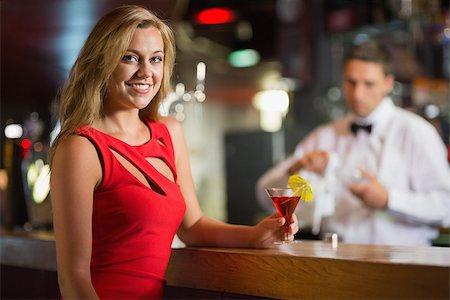 simsearch:693-06021224,k - Pretty blonde smiling at camera with cocktail in a bar Stock Photo - Budget Royalty-Free & Subscription, Code: 400-07939889