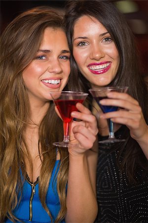 simsearch:400-07939979,k - Pretty friends drinking cocktails together at the nightclub Fotografie stock - Microstock e Abbonamento, Codice: 400-07939904