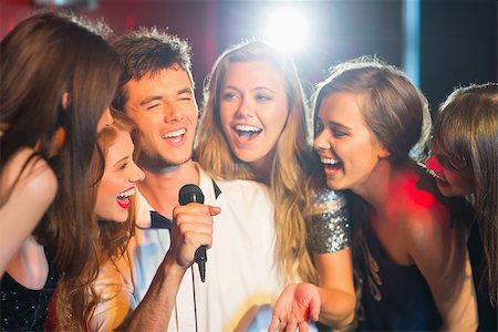 Happy friends singing karaoke together in a bar Stock Photo - Budget Royalty-Free & Subscription, Code: 400-07939918