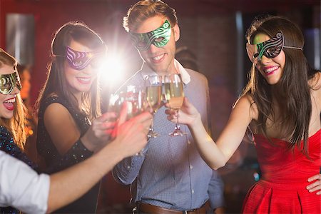 simsearch:632-07809541,k - Friends in masquerade masks toasting with champagne at the nightclub Stock Photo - Budget Royalty-Free & Subscription, Code: 400-07939938