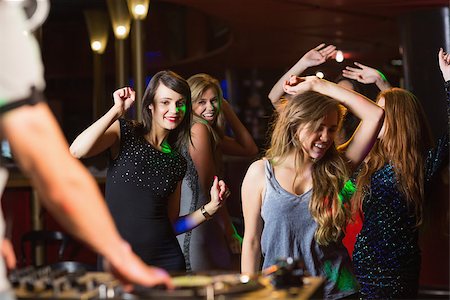 simsearch:400-07939979,k - Happy friends dancing by the dj booth at the nightclub Fotografie stock - Microstock e Abbonamento, Codice: 400-07939976