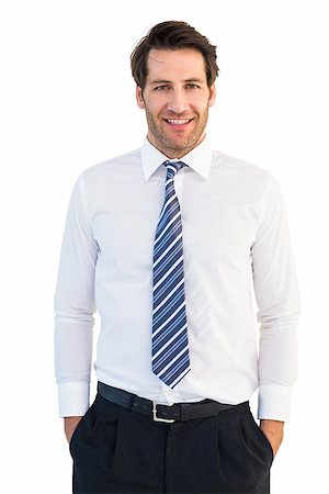 Smiling businessman standing with hands in pockets on white background Stock Photo - Budget Royalty-Free & Subscription, Code: 400-07930063