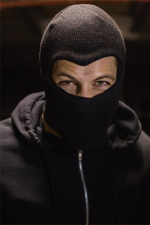 simsearch:693-07444431,k - Portrait of burglar wearing a balaclava on black background Photographie de stock - Aubaine LD & Abonnement, Code: 400-07930102