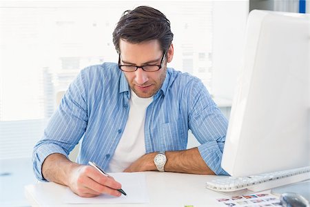 simsearch:400-06885294,k - Photo editor writing on a paper in office Stockbilder - Microstock & Abonnement, Bildnummer: 400-07930220