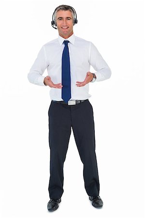 Smiling businessman wearing a headphone on white background Stock Photo - Budget Royalty-Free & Subscription, Code: 400-07930435