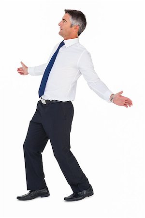 person spreading arms - Side view of a businessman with arms out on white background Stock Photo - Budget Royalty-Free & Subscription, Code: 400-07930452