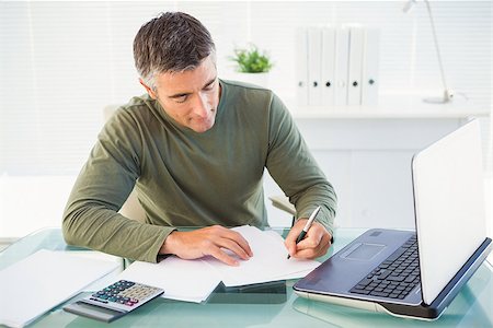 simsearch:400-04082460,k - Man working with laptop and writing in his office Stock Photo - Budget Royalty-Free & Subscription, Code: 400-07930662