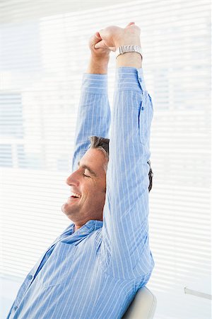 Happy businessman stretching his arms in his office Stock Photo - Budget Royalty-Free & Subscription, Code: 400-07930740