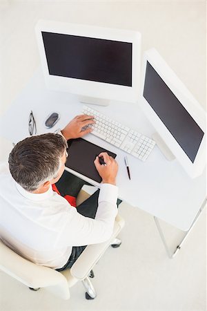 simsearch:400-06879262,k - Businessman using computer and tablet in his office Stock Photo - Budget Royalty-Free & Subscription, Code: 400-07930762