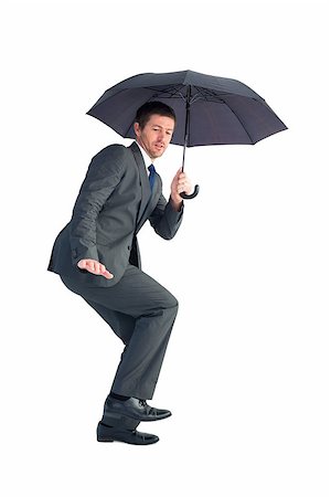 simsearch:400-08264445,k - Businessman sheltering under black umbrella on white background Stock Photo - Budget Royalty-Free & Subscription, Code: 400-07930879