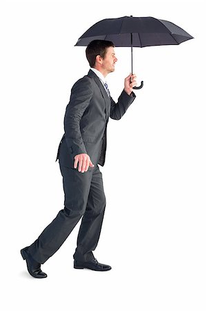 simsearch:400-08264445,k - Businessman sheltering under black umbrella on white background Stock Photo - Budget Royalty-Free & Subscription, Code: 400-07930881