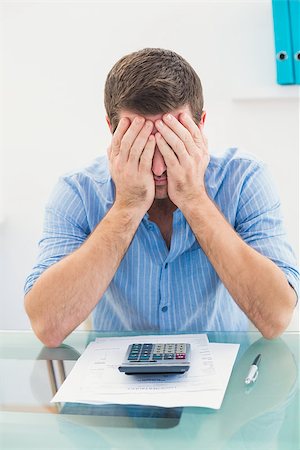 simsearch:400-07931035,k - Stressed businessman covering his face at his desk in his office Stock Photo - Budget Royalty-Free & Subscription, Code: 400-07931036