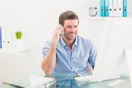 simsearch:400-07931035,k - Smiling businessman on the phone at desk in his office Stock Photo - Budget Royalty-Free & Subscription, Code: 400-07931046