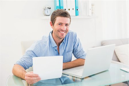 simsearch:400-07931035,k - Smiling businessman holding document in his office Stock Photo - Budget Royalty-Free & Subscription, Code: 400-07931051