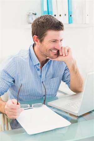 simsearch:400-07931035,k - Smiling businessman at his desk with laptop in his office Stock Photo - Budget Royalty-Free & Subscription, Code: 400-07931053