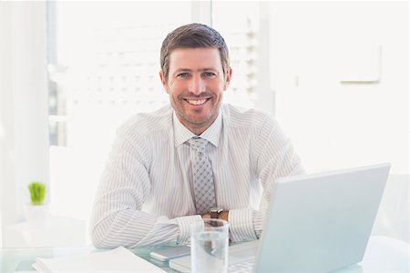 simsearch:400-07931035,k - Smiling businessman at desk in his office Stock Photo - Budget Royalty-Free & Subscription, Code: 400-07931060