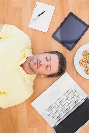 simsearch:400-07931092,k - Man lying on floor surrounded by various objects at home in the living room Foto de stock - Super Valor sin royalties y Suscripción, Código: 400-07931094