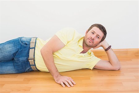 simsearch:6109-08390353,k - Man lying on floor at home in the living room Stock Photo - Budget Royalty-Free & Subscription, Code: 400-07931096