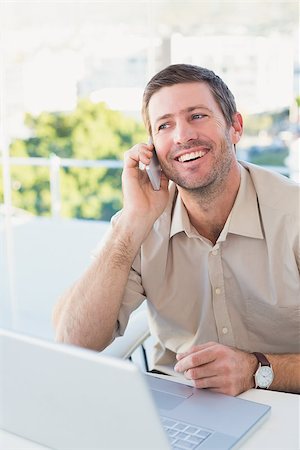 simsearch:400-07931035,k - Smiling businessman making a call at his desk in his office Stock Photo - Budget Royalty-Free & Subscription, Code: 400-07931119