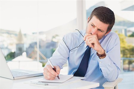 simsearch:400-07931035,k - Worried businessman writing on is notepad in his office Stock Photo - Budget Royalty-Free & Subscription, Code: 400-07931135