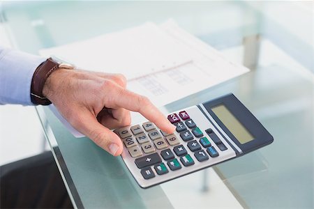 simsearch:400-07931035,k - Businessman pushing key on calculator in his office Stock Photo - Budget Royalty-Free & Subscription, Code: 400-07931146