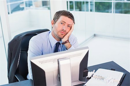 simsearch:400-07931035,k - Bored businessman at his desk in his office Stock Photo - Budget Royalty-Free & Subscription, Code: 400-07931178